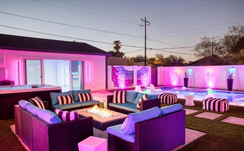 a backyard with purple furniture and a swimming pool at Casa Lumina in Phoenix