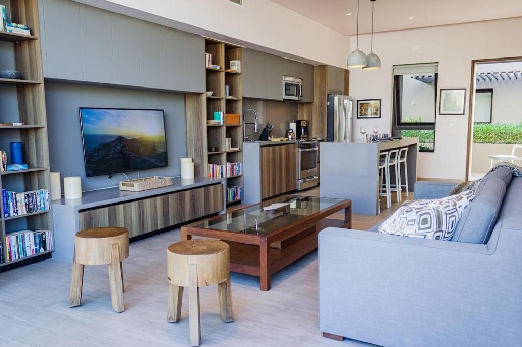 a living room with a couch and a table at Nauti Baja Condo at The Marina Near the Beach in Cabo San Lucas