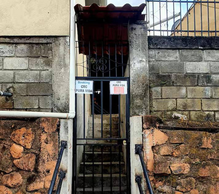 una entrada a un edificio con una puerta de metal en Vicky's Room - NO PARKING SITE, en Santiago Este