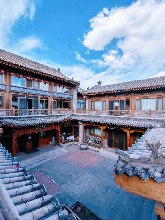 a large building with a pool in front of it at Zhifang Hotel in Datong