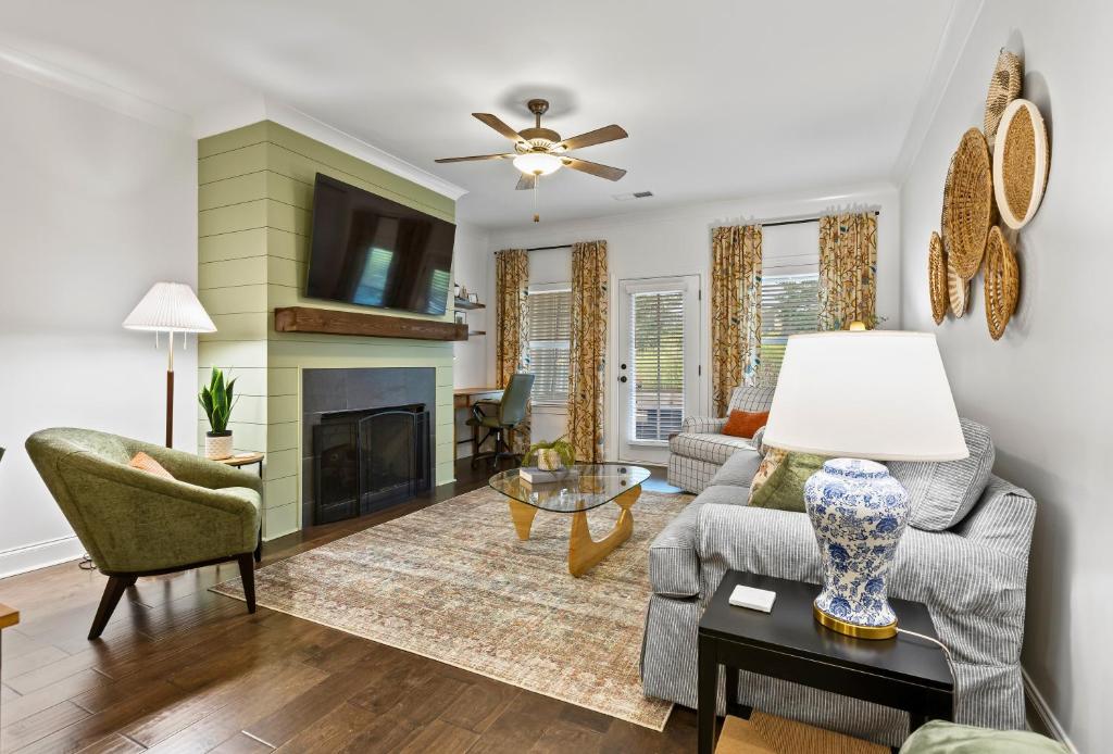 a living room with a couch and a fireplace at Farmville Lakes Tailored Townhouse in Auburn