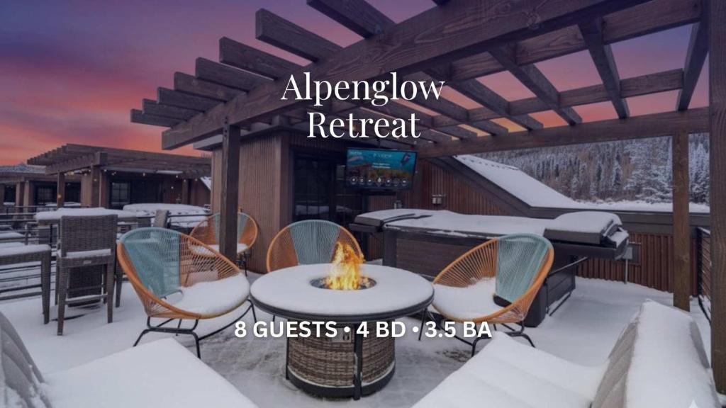 a patio with a fire pit in the snow at Alpenglow Retreat in Winter Park