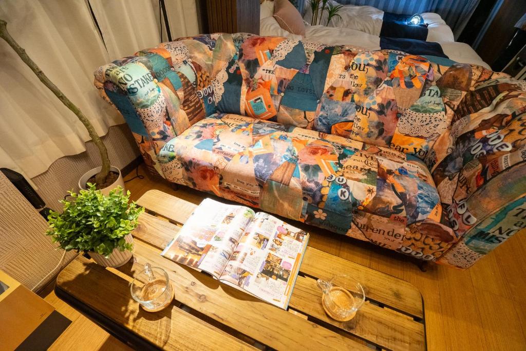 a living room with a couch and a wooden table at MOMOYA nagomi 岡山清輝橋駅徒歩1分 貸切 駐車場付 in Okayama