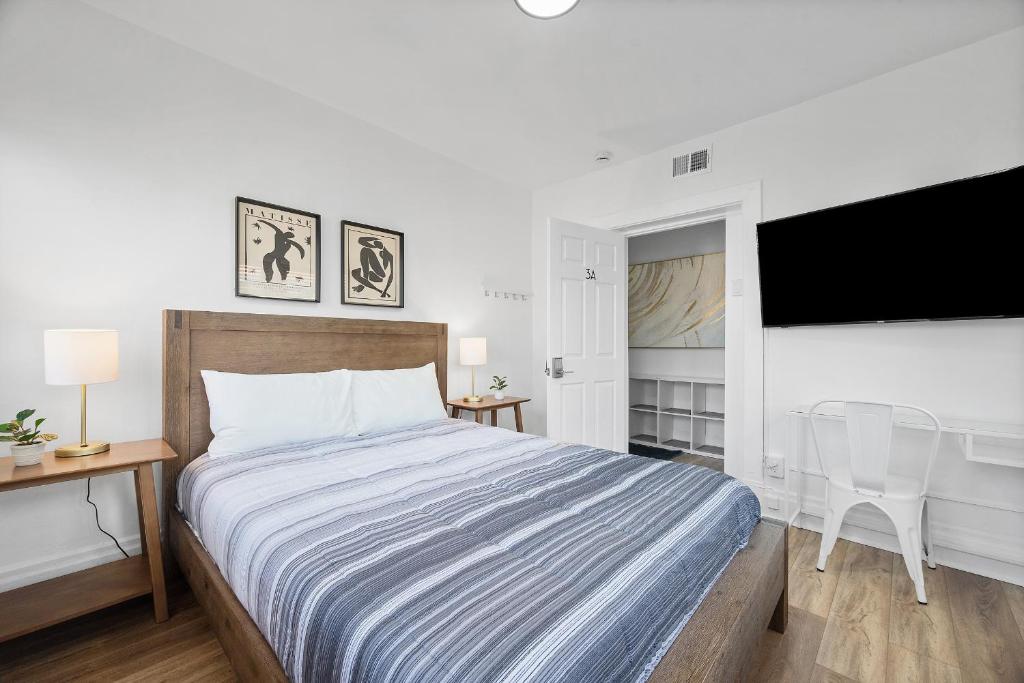 a bedroom with a large bed and a television at Pittsburgh Shadyside 3A Bright and Stylish Private Bedroom with Shared Bathroom in Pittsburgh