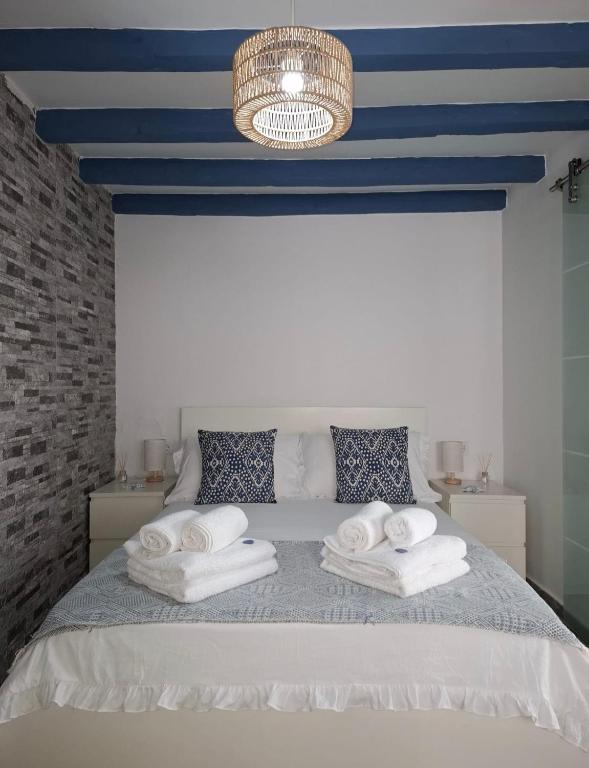 a bedroom with a bed with towels on it at La casita de Paco in Barbate