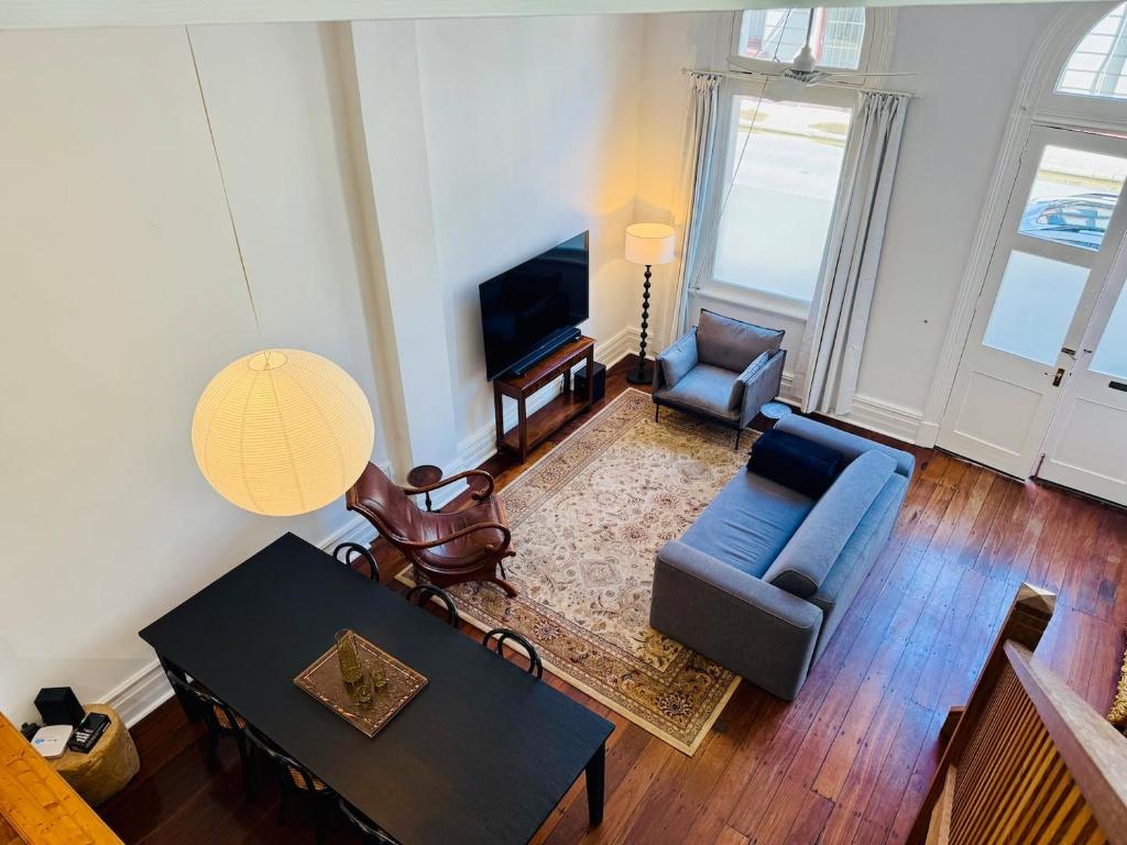 a living room with a blue couch and a table at 42 Lilys Central Heritage Westend in Fremantle