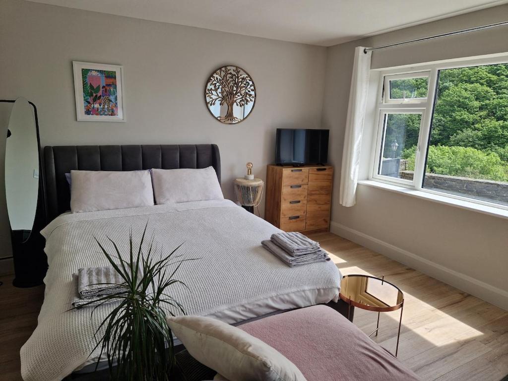 a bedroom with a large bed and a window at La Cabaña - Studio apartment between Leap and Rosscarbery in Leap