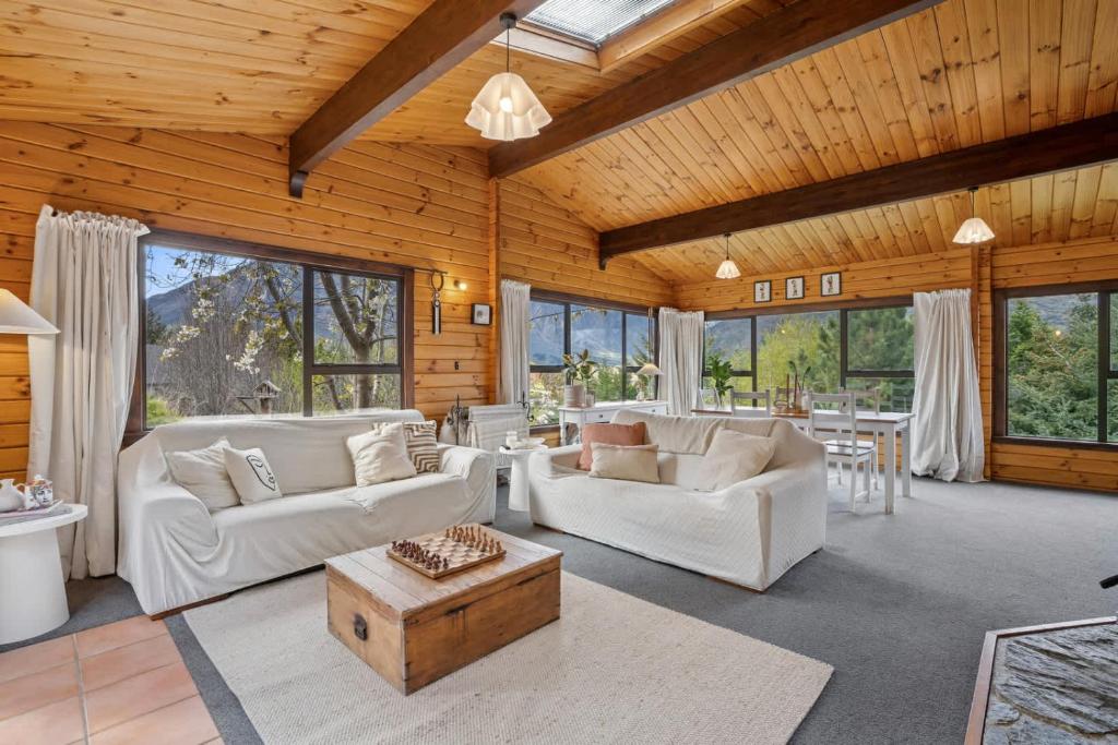 a living room with white furniture and a wooden ceiling at Family-Friendly Chalet Mountain Views in Frankton Wharf