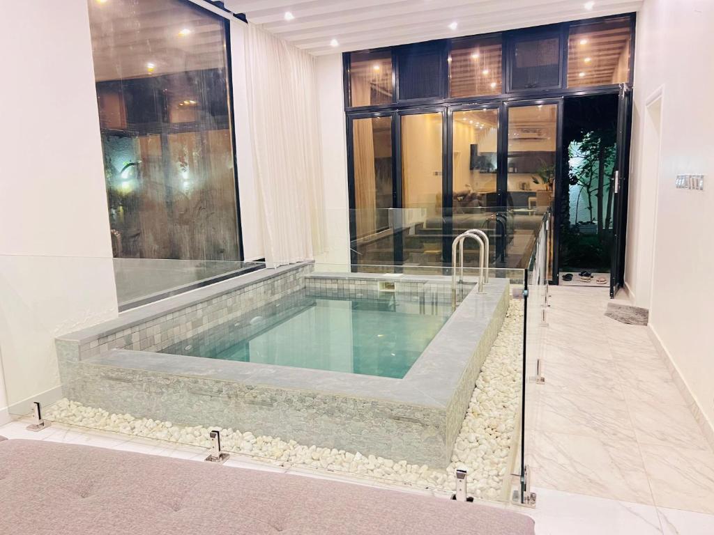 a large swimming pool in a building at MY HOTEL Al Lathba Pool Villa - Nizwa فيلا اللثبه-نزوى in Nizwa