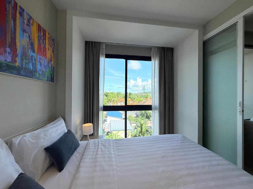 Ένα ή περισσότερα κρεβάτια σε δωμάτιο στο Diamond Resort Phuket Condo Bang Tao Beach