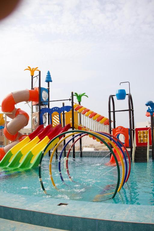 a water park with a water slide in the water at Lina Dreamland Resort in Billah