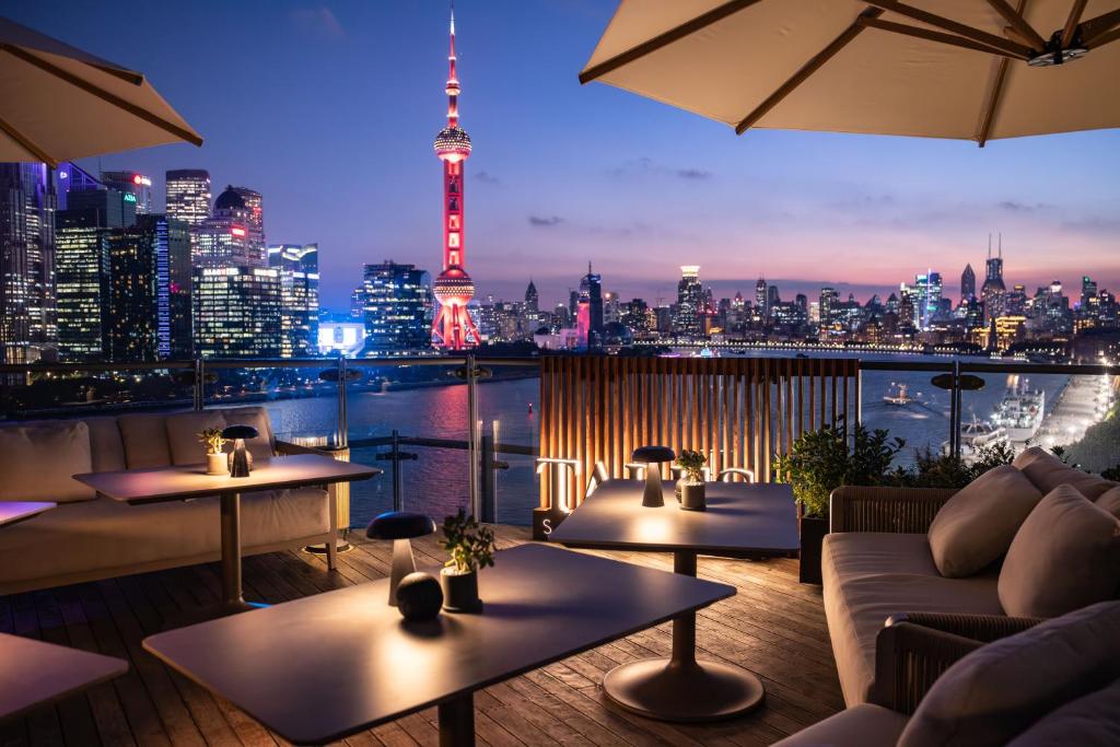 a restaurant with a view of the city at night at Banyantree Shanghai On the Bund - Tales rooftop bar boasts a jaw-dropping panoramic vista in Shanghai