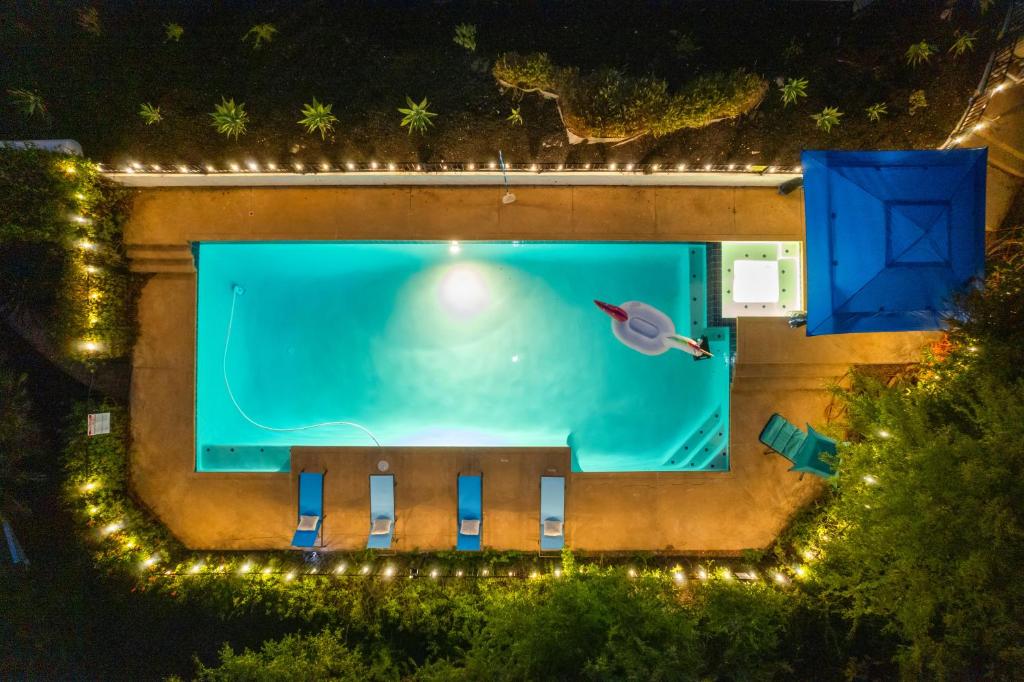 an overhead view of a swimming pool at night at Entire Private Big Yard, View, 4BR, King Bed, 10 Parking, Available Now in El Cajon