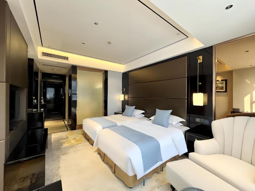 Ένα ή περισσότερα κρεβάτια σε δωμάτιο στο Changzhou Yanling Four Seasons Hotel