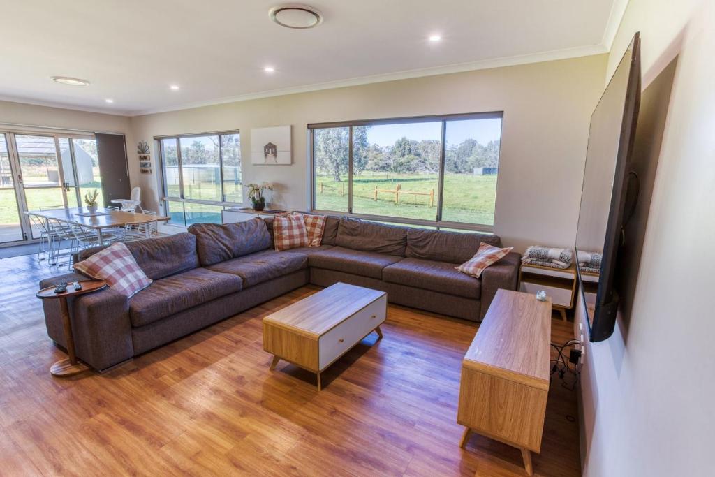 a living room with a couch and a table at Chapman Hill Estate in Busselton