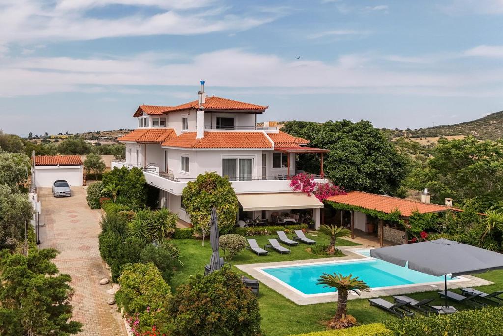 an aerial view of a villa with a swimming pool at Olive Grove Villa in Koropíon