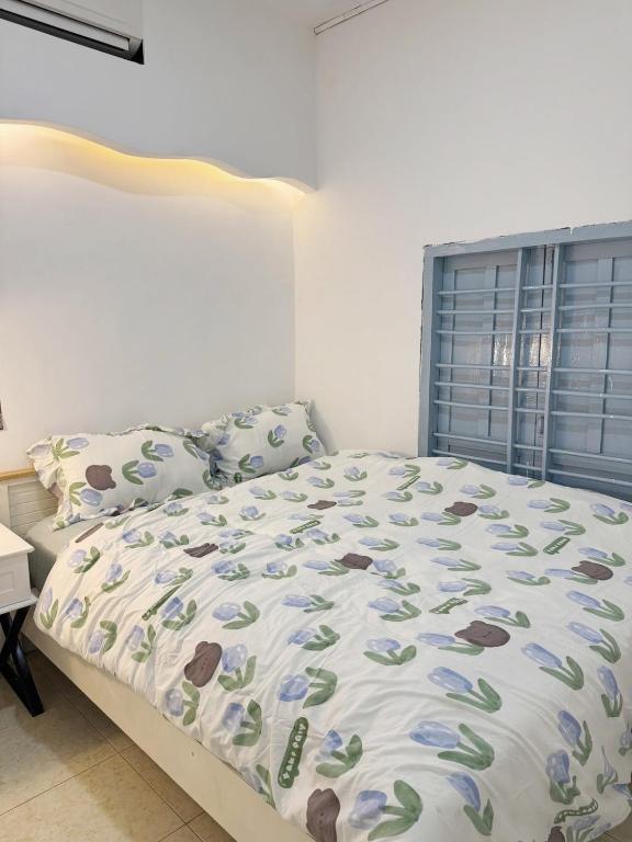 a bedroom with a large bed with a blue headboard at Nap House 2- house in center Phan Thiet in Ấp Bình Hưng