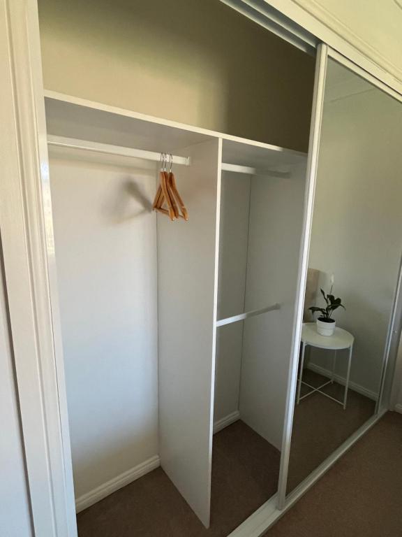 a walk in closet with a glass door at Double room with shared bathoom in Auburn