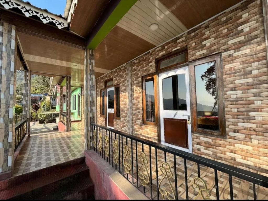 a balcony of a brick building with a railing at Peshok Subba Homestay By StayApart in Darjeeling