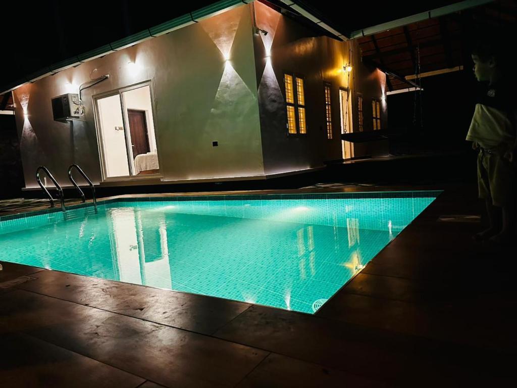 an empty swimming pool in a dark room at ThunderHill by Casablanca - A Premium Pool Villa in Meenangadi