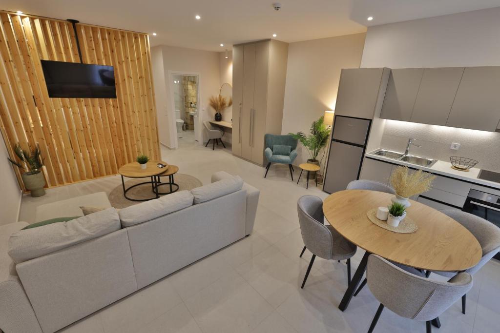 a living room with a couch and a table at LV Apartments Ioannina in Anatolí