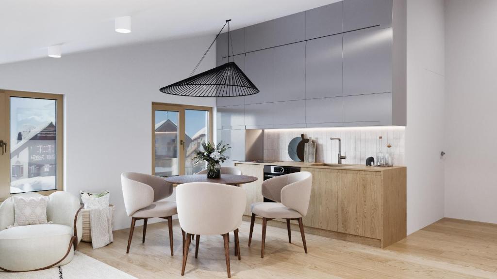 a kitchen and dining room with a table and chairs at Zug503 Appartement in Lech am Arlberg in Lech am Arlberg