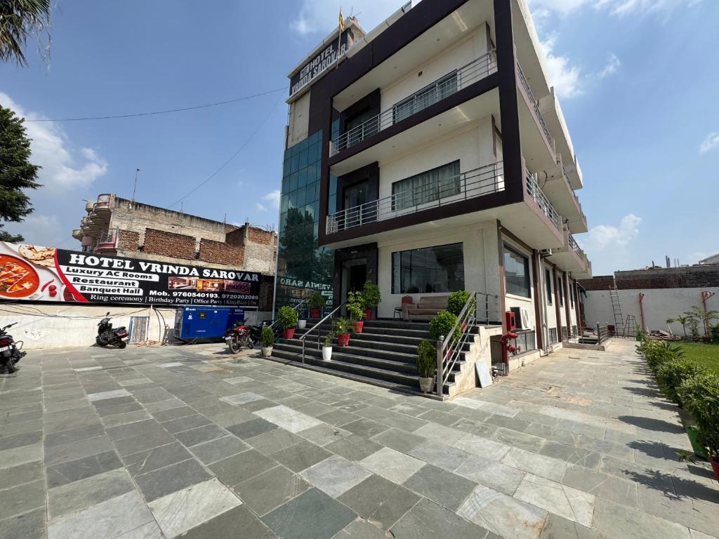 a building with stairs in front of it at Hotel Vrinda Sarovar in Mathura