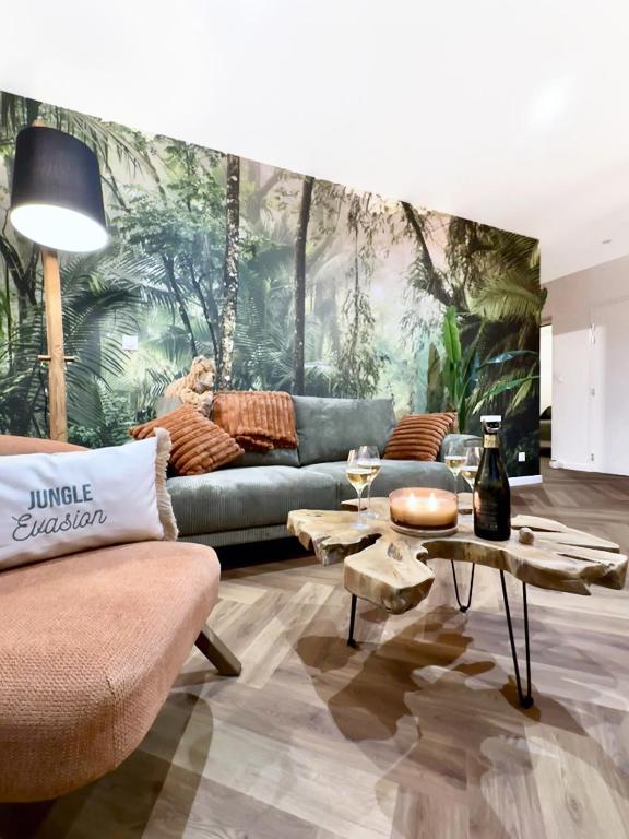 a living room with a couch and a table at Jungle Évasion, Épernay - Jacuzzi & Sauna in Épernay