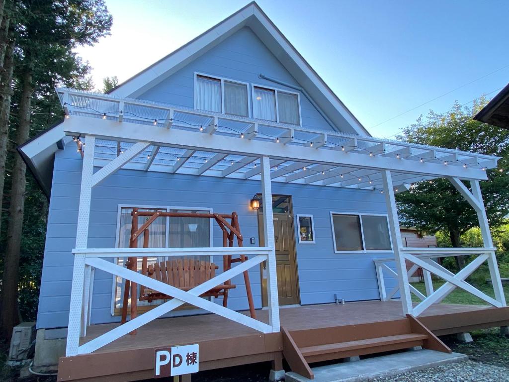 a tiny house with a porch and a deck at 絶景cottageまるっと貸切り 星空D棟 in Nasushiobara