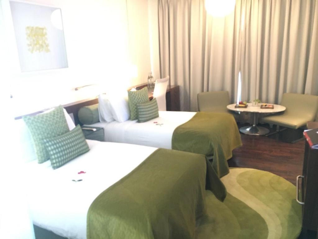 a hotel room with two beds and a table at The Park New Delhi in New Delhi