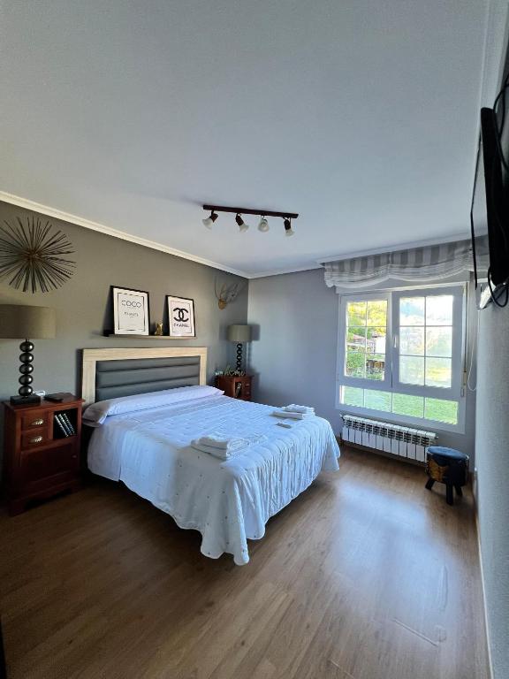 a bedroom with a large bed and a window at Casa Mari Carmen in Salas