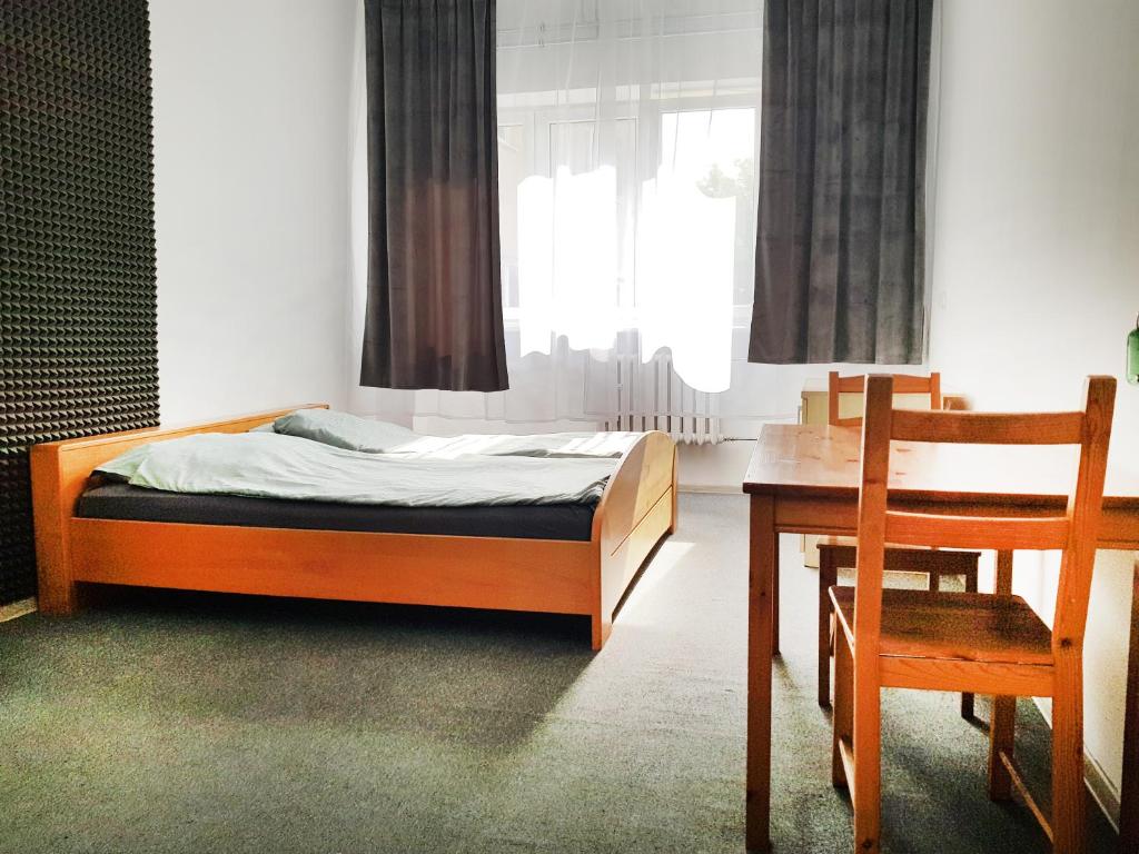 a bedroom with a bed and a desk and a chair at mHostel24 in Lublin
