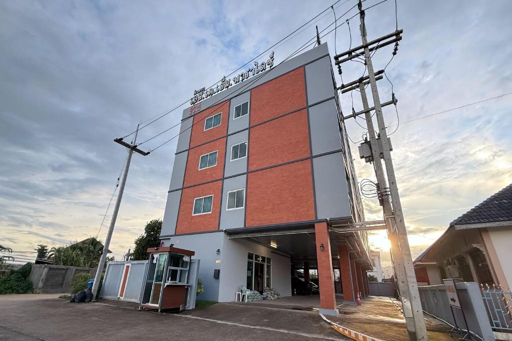 a building with a sign on the side of it at SKM Paradise Mae Sai in Mae Sai