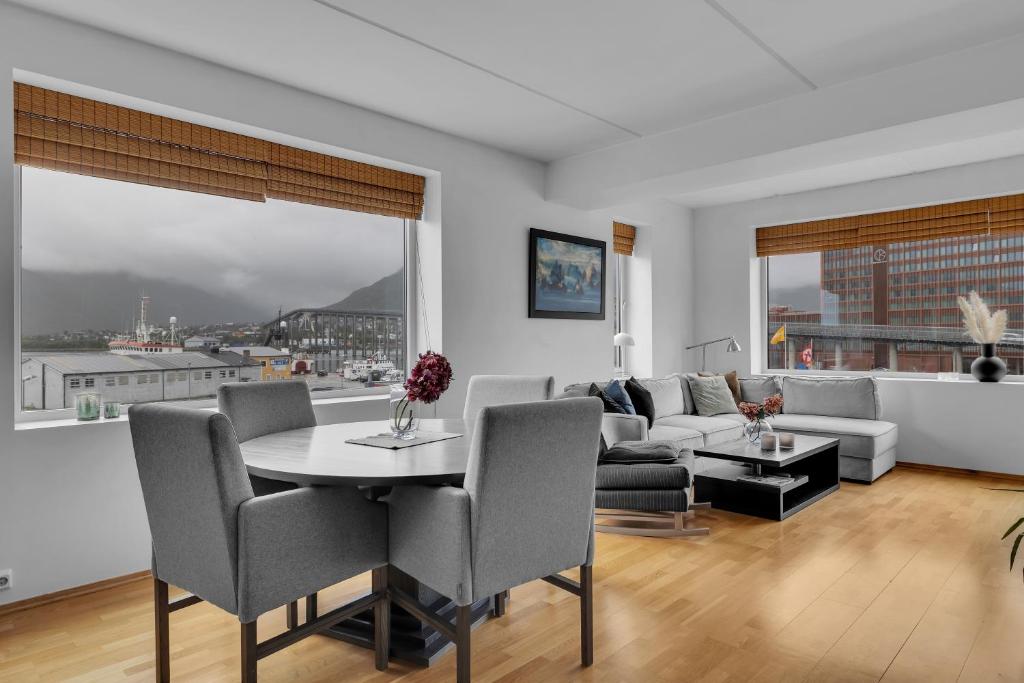 a living room with a table and a couch at Centrally located apartment in Tromsø in Tromsø