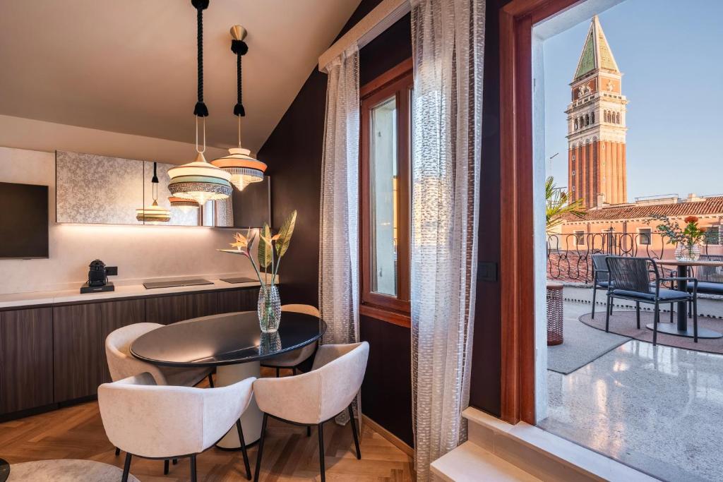 a kitchen and dining room with a view of the city at Palazzo Rota Luxury Apartments in Venice