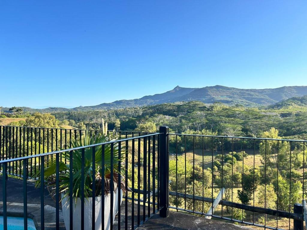 a balcony with a view of the mountains at Chamarel - Enba Lakaz in Chamarel