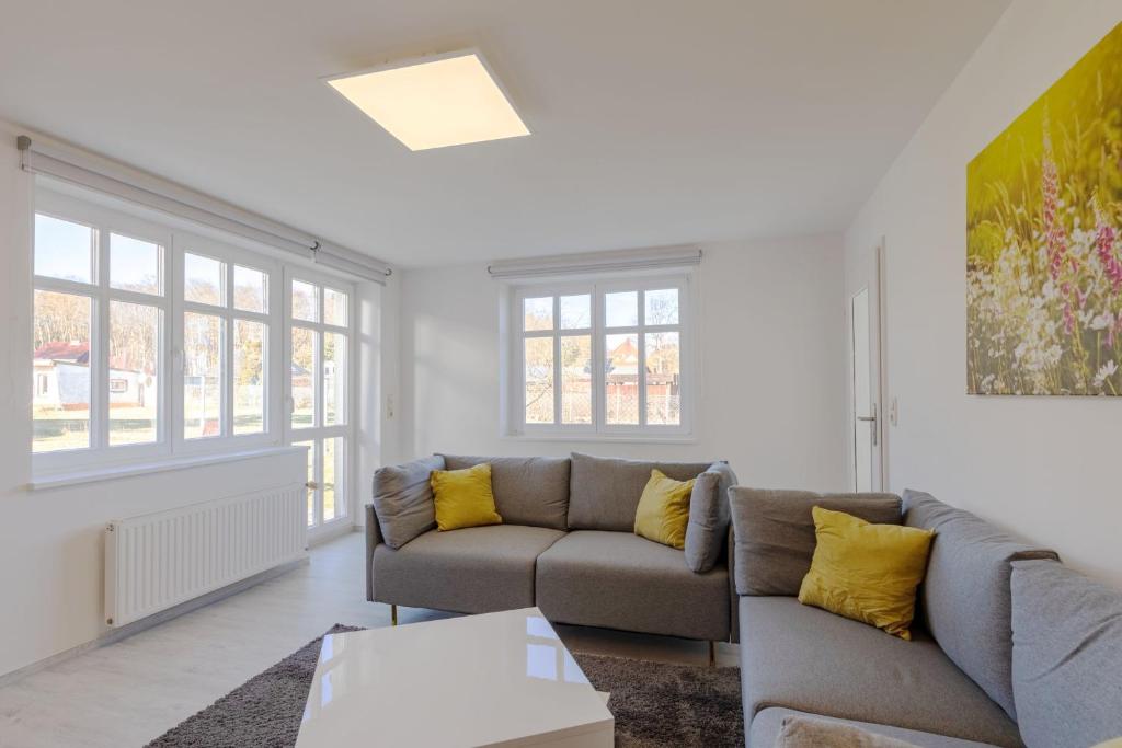 a living room with a couch and a table at StrandLiebe am Strandbad in Malchow
