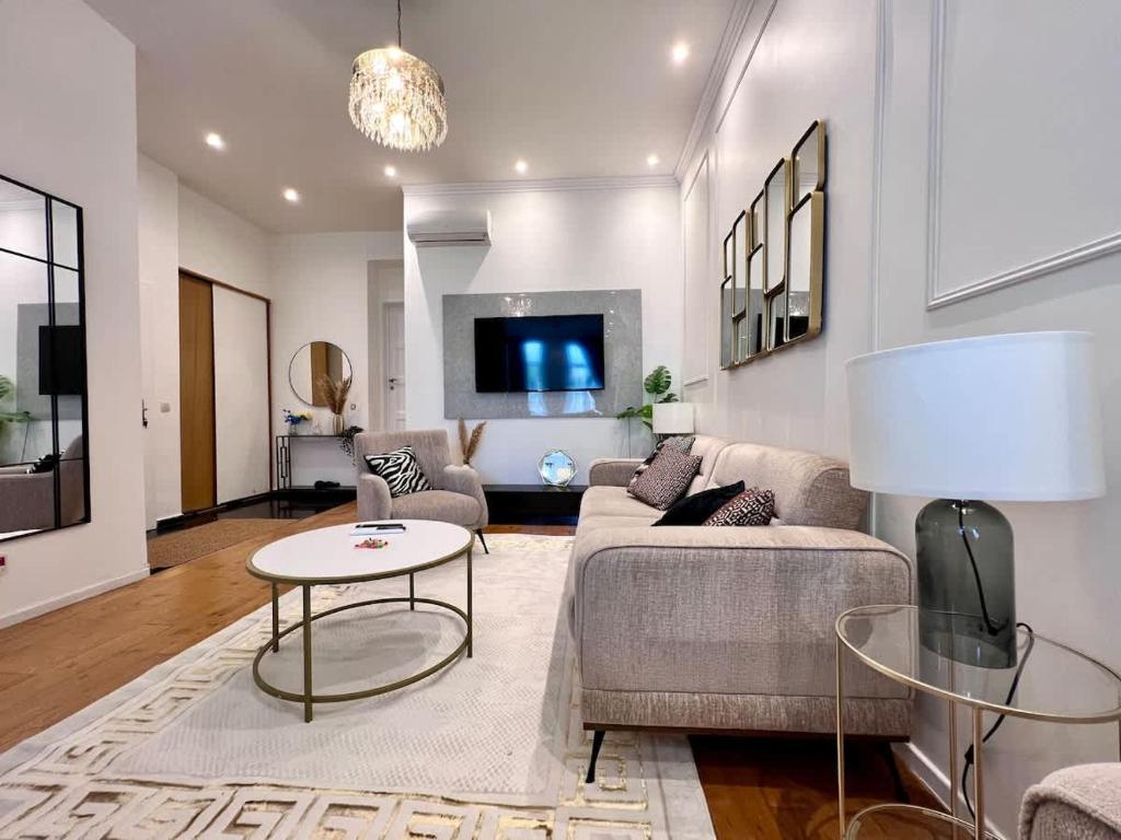 a living room with a couch and a table at Spacious Family Apartment for 9 near Brussels Midi Station in Brussels