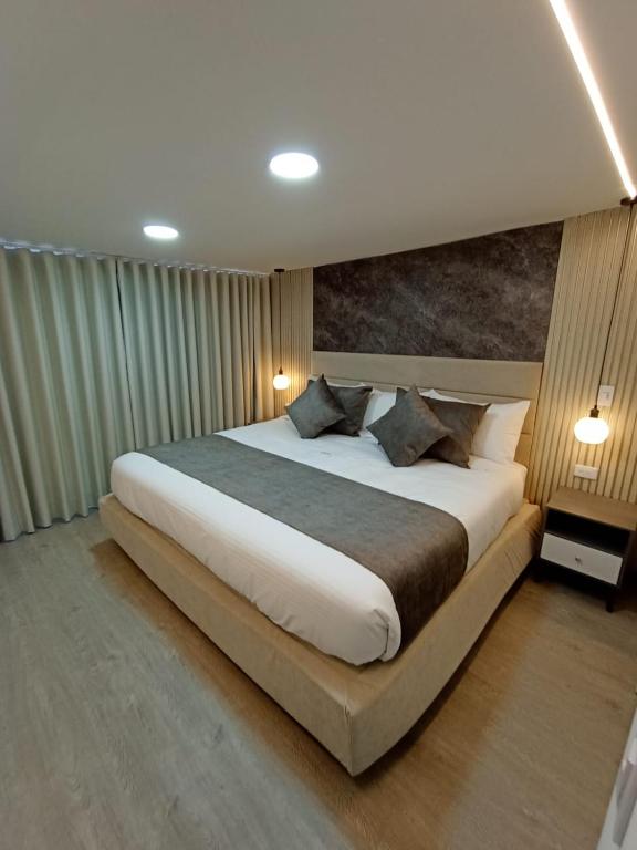 a bedroom with a large bed in a room at Hotel Boutique CGH Aeropuerto in Bogotá