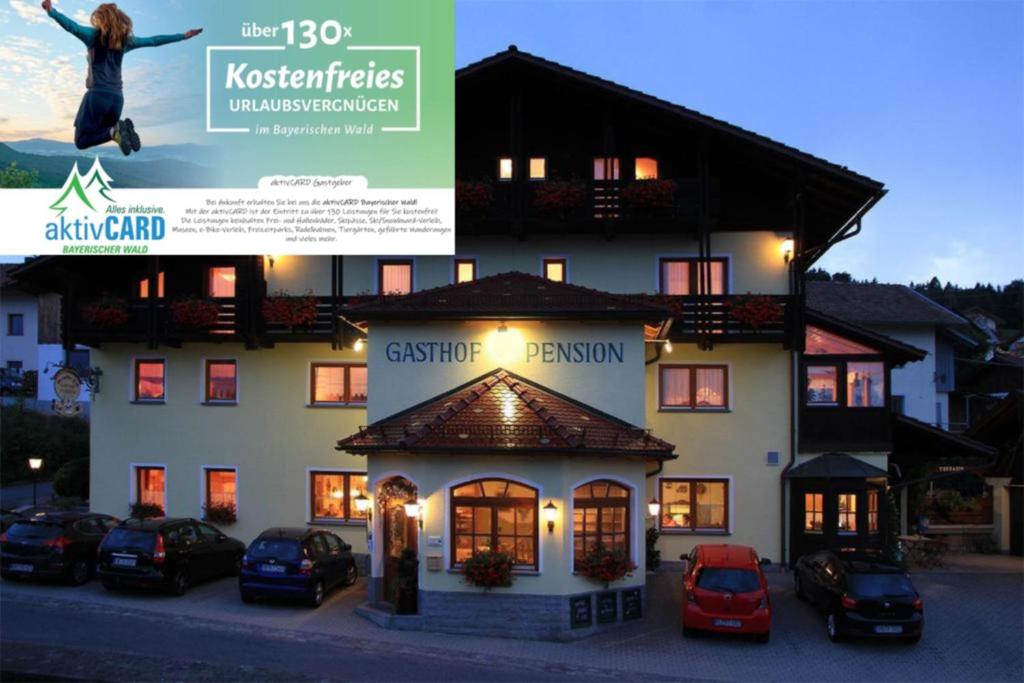 a woman jumping in the air in front of a building at Gästehaus Arracher Hof in Arrach