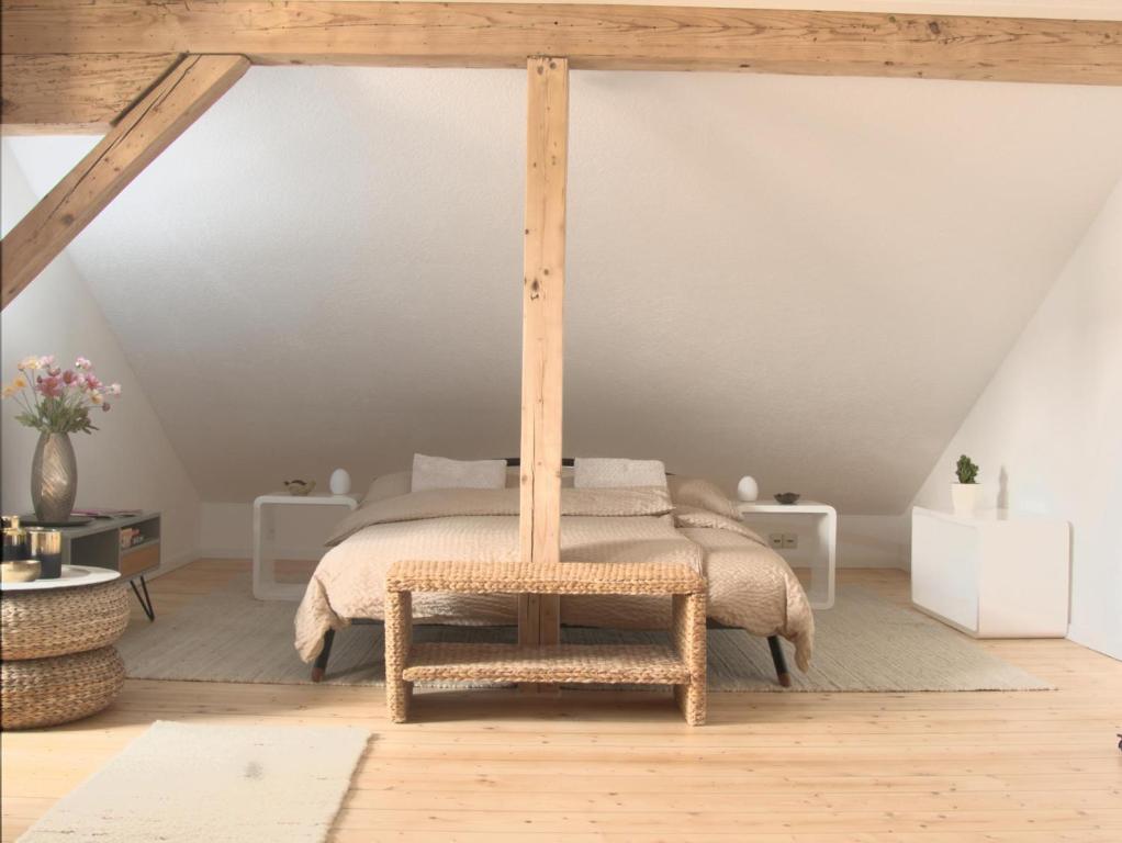 a bedroom with a bed with a wooden canopy at Apartment - Sleeps 3 - Balcony - Garden in Feldkirch
