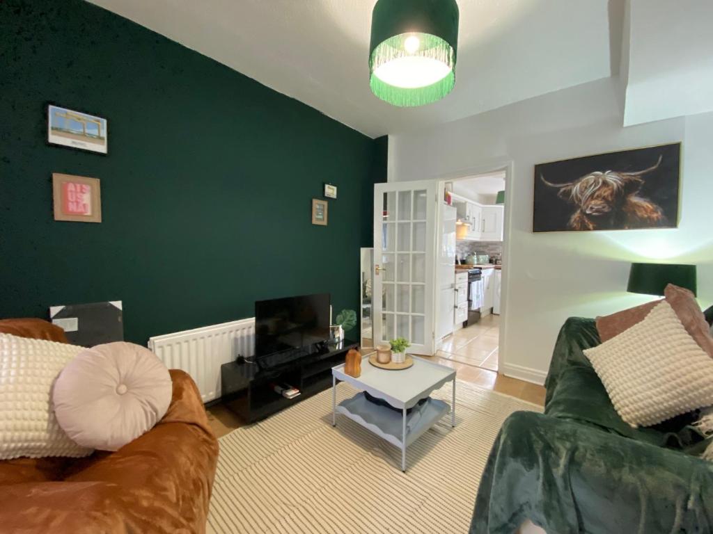 a living room with a couch and a table at Mercer House in Lisburn