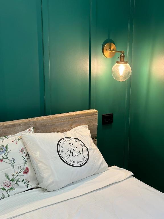 a bedroom with a bed with a pillow and a light at Hidden gem near Fiskars and Billnäs in Raseborg