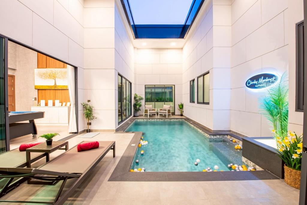 a pool in the middle of a building at Cheeky monkey villa in Nong Prue