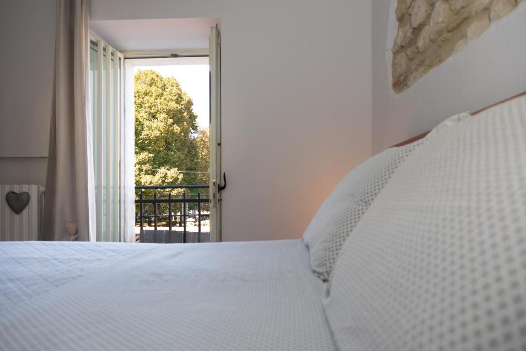 a bedroom with a white bed and a window at Casa Vacanza "Marinella" in Sulmona