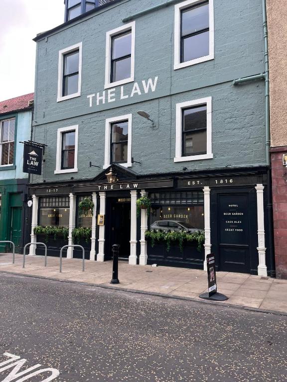 a green building with a sign in front of it at The Law in North Berwick