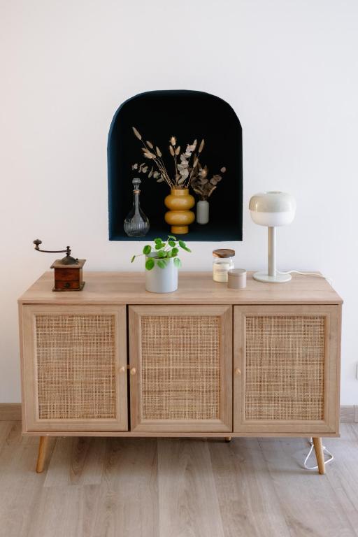 a wooden cabinet with a lamp on top of it at Villa Balma in Beaumes-de-Venise