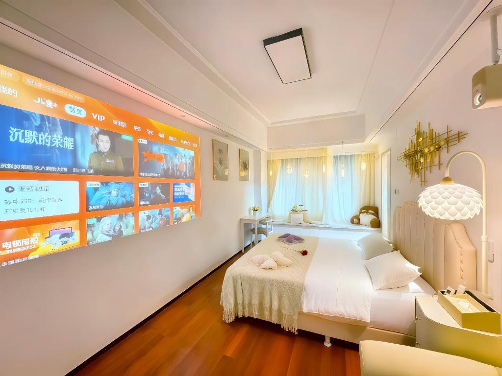 Un dormitorio con una cama y una pantalla grande. en Yundemeisu, en Changsha