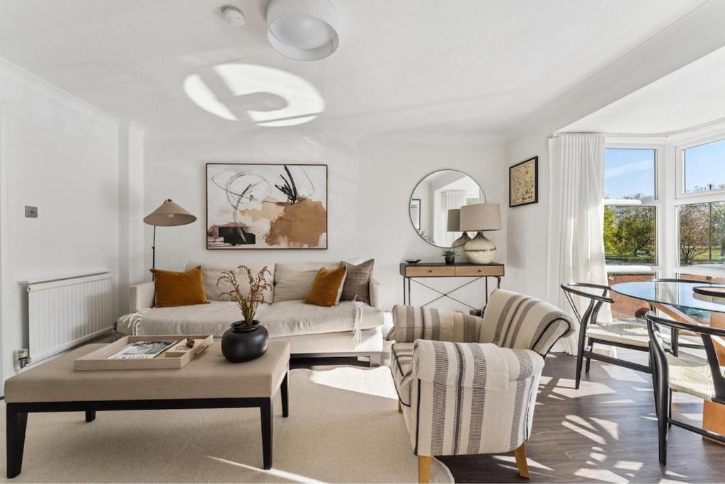 a living room with a couch and a table at Elegant 1-Bed Flat with Parking & Long Walk Views in Windsor