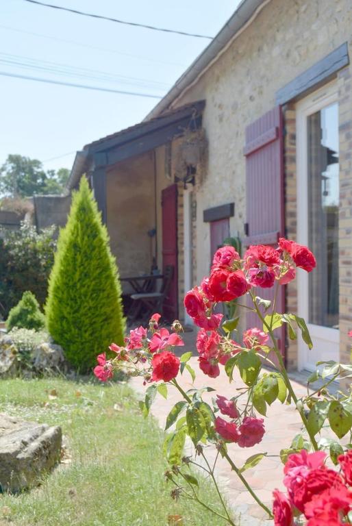 a bunch of red roses in front of a house at La Serenidad in Denonville